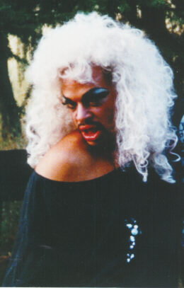 Gryphon in white wig, black dress